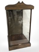 An early 20th century glazed mahogany shop display cabinet with inset plaque marked 'Bullen Bros &