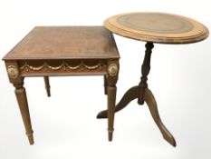 A reproduction lamp table with tooled leather panel and gilt metal mounts,