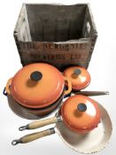 A group of vintage enameled cast iron kitchen pans,