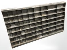 A vintage enameled metal corner stone pigeon hole shelf, 124 cm x 24 cm x 68 cm.