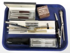 A desk stand incorporating a calendar, various writing utensils including Parker ballpoint pens,