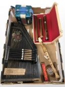 Musical instruments including a zither, recorder, a small Chinese accordion, harmonica, marimba.