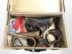 A vintage suitcase containing two bugles, a Swiss army knives,