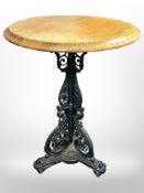 A painted cast iron pub style table with later pine top,