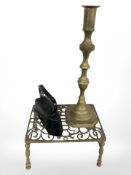 A Victorian pierced brass footman, width 33 cm, a large candlestick and an iron.