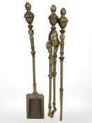 A cast brass three piece fire companion set.
