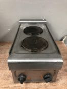 A stainless steel commercial hot plate, together with a three tier trolley.