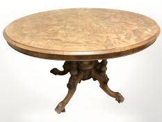 A Victorian burr walnut and satinwood inlaid breakfast table, 118 cm x 85 cm x 70 cm.