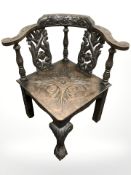 A 19th century heavily carved oak corner armchair,