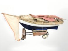 A large wooden pond yacht on trailer stand, length 120 cm.