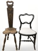 A carved oak spinning chair and a Victorian ebonised and mother of pearl inlaid occasional chair.