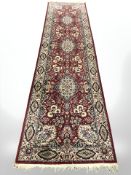 A machine made rug of Persian design, 195 cm x 92 cm.