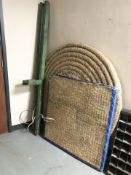 Two straw archery targets and a collapsible stand.
