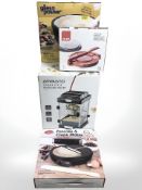 A group of boxed culinary appliances including an Ambiano popcorn maker, a crepe maker, etc,
