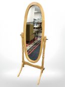A modern cheval mirror and an occasional chair.