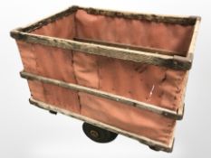 A vintage pine framed cart on trolley castors, length 95 cm.