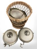 A wicker basket containing Art Deco pendant light fittings