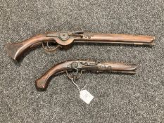 A copy of a wheellock pistol and a further copy of a flintlock, longest 52 cm.
