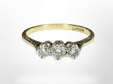 An 18ct yellow gold and platinum three stone diamond ring, size M/N.