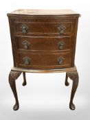 A 20th century mahogany bow-front three drawer chest,