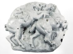 A large painted concrete plaque depicting galloping horses, diameter 60 cm.