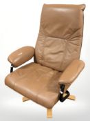 A Unico tan leather swivel armchair on bentwood support.