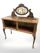 An oak side table fitted with shelf beneath on cabriole legs,