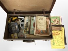 A vintage luggage case containing film reels, souvenir programmes, ephemera, etc.