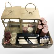 Two glazed metal lanterns and a quantity of candles.