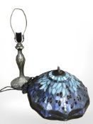 A patinated metal lamp base with Tiffany style dragonfly pattern shade,