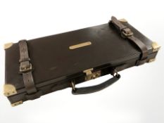 A contemporary leather and brass mounted cartridge case, width 55 cm.