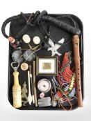 A leather whip, pipe, recorder, timer, lighter, child's rattle,