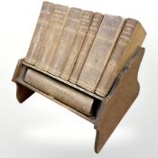 A set of Asprey Reference Library books on oak book trough