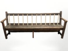 A Victorian stained pine railway bench, 215 cm long.