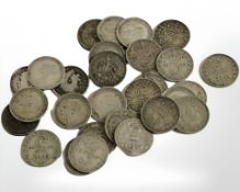A collection of George V three pence pieces.