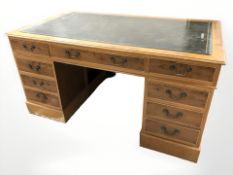 A reproduction yew wood nine drawer twin pedestal desk, 152 cm x 90 cm x 77 cm.
