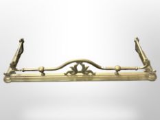 A Victorian brass fire curb, width 135 cm.