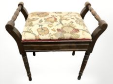 A piano storage stool with embroidered seat