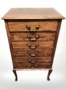 An Edwardian six drawer music cabinet on cabriole legs,