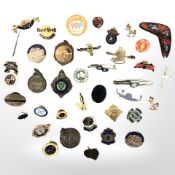 A collection of silver and other badges.
