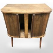 A teak tambour front record cabinet, width 61 cm.