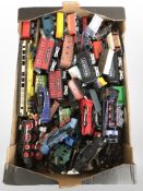 A group of die cast metal and plastic locomotives, passenger cars and rolling stock.