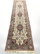 A machine made runner of Persian design,