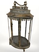 A reproduction glazed gilt metal octagonal cabinet with carry handle, height 67 cm.