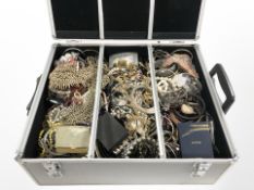 An aluminium jewellery case containing a large quantity of costume necklaces, bangles, pendants,