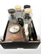 A group of brass ornaments, glass storage jars, two mantle clocks, inert brass shells,