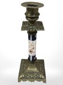 A Victorian brass candlestick with porcelain column, height 22 cm.