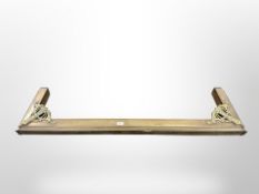 A Victorian brass fire curb,