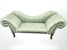 An early 20th century chaise longue in green floral fabric,