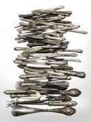 A large collection of silver handled items including sets of knives, button hooks, shoe horns, etc.